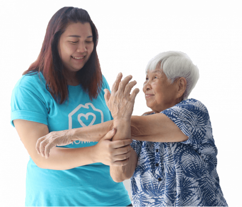 Homage Caregiver helping an elderly woman stay active with simple arm exercises