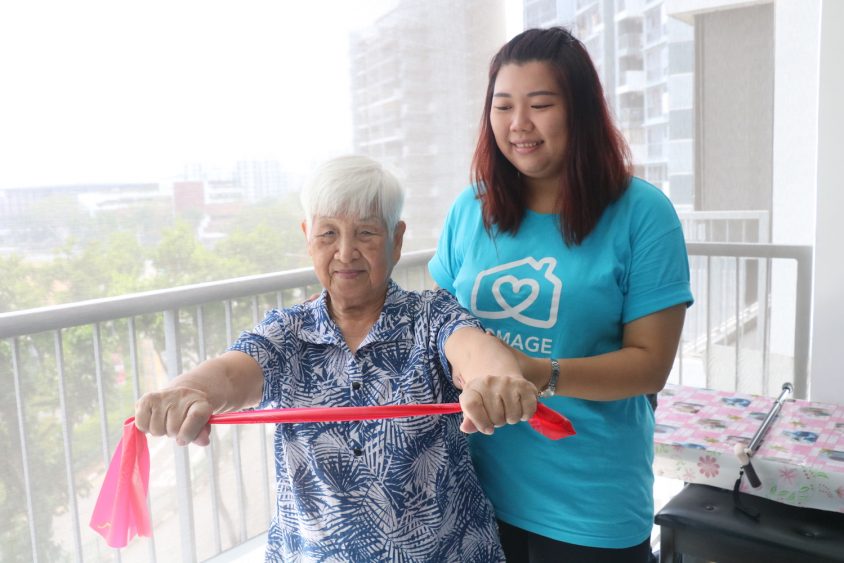 Homage Care Professional helping elderly woman to stay physically active with resistance band exercises